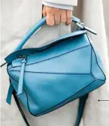  ??  ?? “In duck-egg blue, the Loewe Puzzle Bag reinforces its status as a must-have on the fashion circuit.”