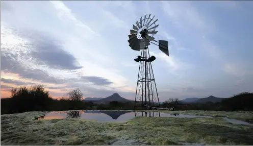  ?? PHOTO: REUTERS ?? A windmill pumps water from a borehole near Graaff-Reinet in the Karoo in this file picture. Stretching across the heart of South Africa, the Karoo has stirred emotions for centuries, a stunning semi-desert wilderness, fit mainly for artists, hunters...