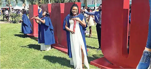  ??  ?? Kayla Taylor celebrates after graduating from The University of the West Indies, Mona Campus, earlier this month.