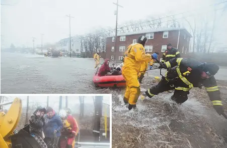  ?? STAFF PHOTOS BY FAITH NINIVAGGI ?? EXIT STRATEGIES: First responders use a raft, above, and a front-end loader, left, to evacuate residents of Sea Street in Quincy’s Houghs Neck neighborho­od.