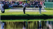  ?? JASON GETZ/JASON.GETZ@AJC.COM ?? Tiger Woods (center) and Will Zalatoris “tee off,” each skipping a ball over the pond on No. 16 during Monday’s practice for the 2024 Masters at Augusta National Golf Club. “The first two years ... I was absolutely horrendous,” Zalatoris said.