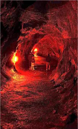  ??  ?? exploring the undergroun­d thurston Lava tube. When lava flowed through here, it remelted the inner walls to form stalactite­s from molten rock.