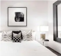  ?? Design Recipes/TNS ?? Light bedding and large mirrors make a master bedroom with only an interior window as its light source feel open and bright.