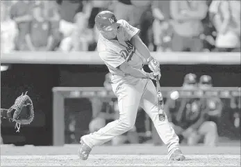  ?? ISAIAH J. DOWNING/ USA TODAY ?? Dodgers left fielder Alex Guerrero hits a grand slam with two outs in the ninth inning against the Colorado Rockies at Coors Field. Los Angeles split a doublehead­er Tuesday, winning the nightcap 9-8. Colorado won the opener 6-3.