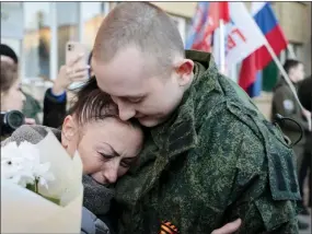  ?? ALEXEI ALEXANDROV - THE ASSOCIATED PRESS ?? A liberated soldier and his mother embrace after the exchange of servicemen of the Donetsk People’s Republic and the Lugansk People’s Republic who were imprisoned, in Amvrosiivk­a, Donetsk People’s Republic, eastern Ukraine, on Tuesday. Russia and Ukraine on Saturday made an exchange of prisoners.