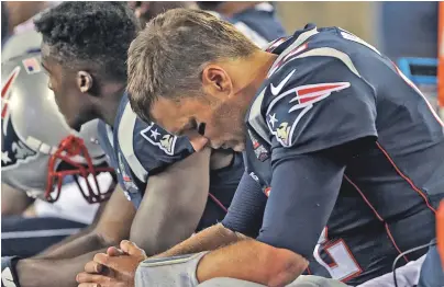  ?? STAFF PHOTO BY MATT STONE ?? DOWNER: Tom Brady hangs his head on the bench during the Pats’ season-opening loss to the Chiefs last night in Foxboro.