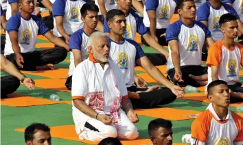  ?? — PRITAM BANDYOPADH­YAY ?? Prime Minister Narendra Modi performs yoga asanas during a mass yoga event on the 4th Internatio­nal Yoga Day at the Forest Research Institute grounds in Dehradun on Thursday.