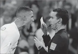  ?? REUTERS ?? Portugal forward Cristiano Ronaldo is none too pleased at being booked by referee Cesar Arturo Ramos during a FIFA World Cup match against Uruguay in Sochi, Russia on June 30.