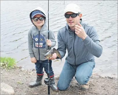  ?? KEVIN ADSHADE/THE NEWS ?? Chris Baldwin and his son Asa hold a fish caught at Trenton Park.