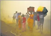  ?? AJAY AGGARWAL /HT PHOTO ?? Migrant workers walking towards Farrukhaba­d and Sultanpur pause during a sudden dust storm.