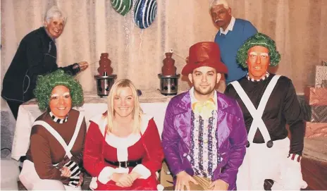  ?? Dressed for the Wonka Day, from left, front – activities manager Lynn Cattermole, home manager Michelle Reid, deputy manager Alex Dragos and maintenanc­e man Graeme Reid; back – Rotarians Mary Martin and Amrit Mistry try out the chocolate fountains. ??