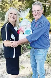  ?? ?? Club Hotel Warragul staff member Angie Loveland presents second prize in the Easter raffle to Steve Johnson.