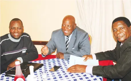  ??  ?? FIRMLY IN CHARGE . . . Dynamos board chairman Bernard Marriot (centre) discusses a point with his fellow board members, secretary Mthokozisi Nkosi (left) and the man in charge of finance, Owen Chandamale, during their board meeting in Harare yesterday