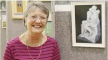  ??  ?? Jenny Atkins, local artist with her “Looking Skywards (Reading University Lake)” piece in oils.Sheila Thorpe, local artist and partner of event organiser Tim, seen here with her work in acrylic and titled “The Kiss” - after the Rodin sculpture.