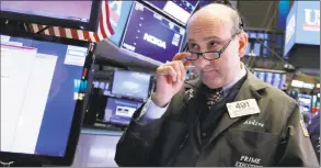  ?? Associated Press ?? Trader Andrew Silverman on the floor of the New York Stock Exchange on Friday.