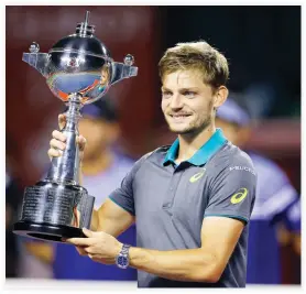  ??  ?? David Goffin of Belgium with the trophy after beating Adrian Mannarino of France during their men's singles final match of the Japan Open tennis tournament in Tokyo Sunday. (AP)