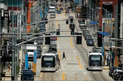  ?? The Associated Press ?? INFRASTRUC­TURE PROJECTS: Streetcars travel through Kansas City, Mo., on Friday. Officials are concerned that a 25 percent tariff on imported steel will boost the cost of a $250 million planned expansion of the city’s streetcar line.