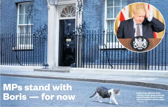  ?? ?? British Prime Minister Boris Johnson (inset) spent yesterday inside Downing Street as anger over his lockdown parties raged.
Photos / AP