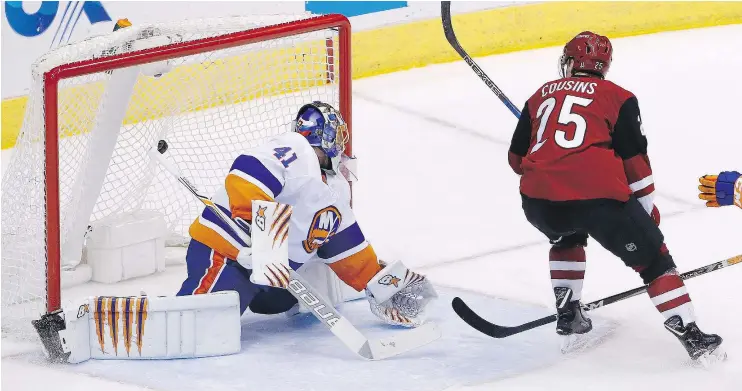  ?? — AP FILES ?? Nick Cousins of the Coyotes scores in OT on Islanders goalie Jaroslav Halak. So far in 2017-18, two-thirds of overtime periods have ended before the final buzzer.