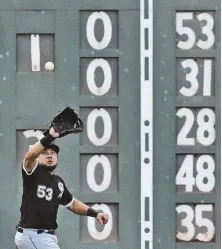  ?? AP FILE PHOTO; HERALD FILE PHOTO, LEFT ?? STILL ON DISPLAY: Chicago White Sox' Melky Cabrera is about to make a catch in a 2016 game by one of the scoreboard white lines that spell — in Morse code — the initials of the late Tom Yawkey and his wife, Jean, pictured at left.