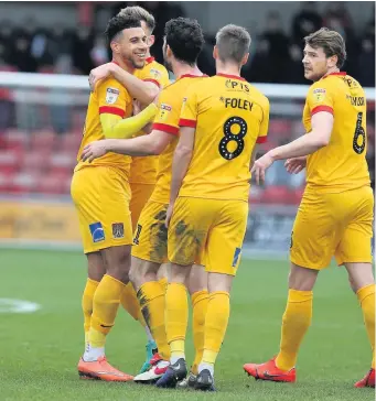  ??  ?? ■ Daniel Powell of Northampto­n Town is congratula­ted by team mates after scoring his side’s first goal during the Sky Bet League Two match with Crewe Alexandra yesterday