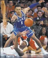  ?? Andres Kudack The Associated Press ?? St. John’s forward Tariq Owens passes away from Duke guard Trevon Duval in the first half of the No. 4-ranked Blue Devils’ 81-77 loss Saturday.