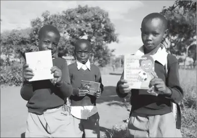  ?? PROVIDED TO CHINA DAILY ?? African children in Tanzania hold free anti-malaria brochures offered by Guilin Pharmaceut­ical Co Ltd on the World Malaria Day on April 25.