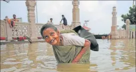  ?? AP ?? ■ An elderly woman wades through Ganga waters in Varanasi on Sunday.