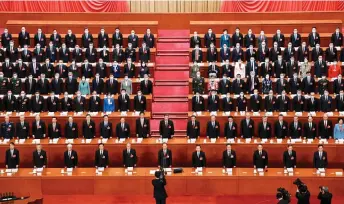  ?? — AFP photo ?? Fle photo shows Xi (centre) and other Chinese leaders singing the national anthem during the opening session of the National People’s Congress (NPC) at the Great Hall of the People in Beijing.