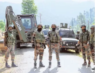  ??  ?? ARMY JAWANS STANDING GUARD near an encounter site in the Nagnad area of Kulgam district, south Kashmir, on July 17, where three Jaish-emohammed militants were killed in a gunbattle with security forces. Three army personnel were also injured in the operation.