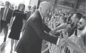  ?? ASSOCIATED PRESS ?? President Donald Trump shakes hands as he arrives to speak to U.S. military troops and their families at Naval Air Station Sigonella on Saturday in Italy.