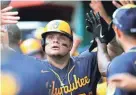  ?? DAVID KOHL/USA TODAY SPORTS ?? Daniel Vogelbach gets high-fives in the Brewers dugout after hitting a two-run home run during the seventh inning.