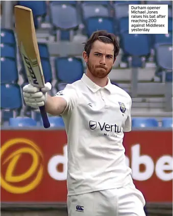  ?? ?? Durham opener Michael Jones raises his bat after reaching 200 against Middlesex yesterday