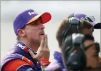  ?? PAUL SANCYA — THE ASSOCIATED PRESS ?? Denny Hamlin watches qualificat­ions for a NASCAR Cup Series auto race at Michigan Internatio­nal Speedway in Brooklyn, Mich., Friday. Hamlin won the pole position.