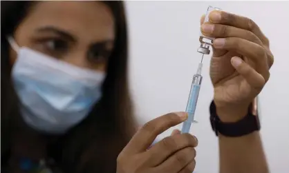  ?? ?? A volunteer draws the AstraZenec­a vaccine at a drop-in centre in June in London. Photograph: Dan Kitwood/Getty Images