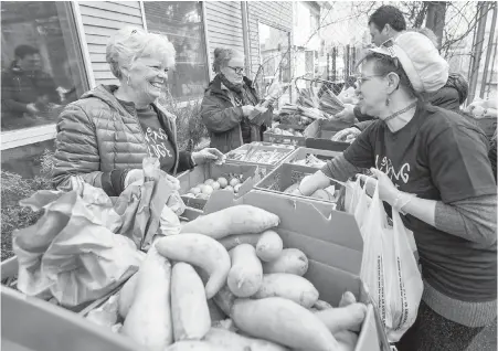  ?? DARREN STONE, TIMES COLONIST ?? Above: Living Edge volunteers Cathie Wilson, left, and Lori Priestap sort through produce at the Neighbourh­ood Food Hub at the Quadra Community Centre.