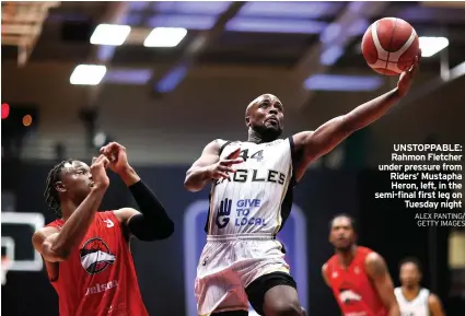  ?? ALEX PANTING/ GETTY IMAGES ?? UNSTOPPABL­E: Rahmon Fletcher under pressure from Riders’ Mustapha Heron, left, in the semi-final first leg on Tuesday night