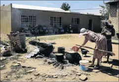  ??  ?? GETTING READY: Women at Pella village, where Moses Kotane was raised, cook for guests who had been streaming into the Kotane homestead for the reburial of late SACP leader’s remains at the weekend. Right: Burial site