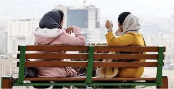  ?? — AFP file photo ?? Women sit on a bench in Parvaz park in the Iranian capital Tehran.