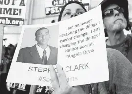  ?? Rich Pedroncell­i Associated Press ?? ANITA ROSS holds a photo of Stephon Clark as she and other protesters block the entrance to Sacramento City Hall in 2018, four days after Clark’s killing.