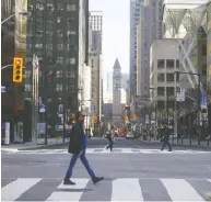  ?? COLE BURSTON / BLOOMBERG FILES ?? The corner of Yonge Street and Bay Street in the financial district of Toronto. Canada's Big Banks have more
money in reserve than required by regulation.