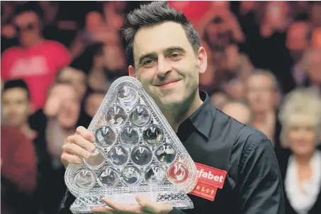 ??  ?? Ronnie O’Sullivan celebrates victory in the Dafabet Masters at Alexandra Palace last night