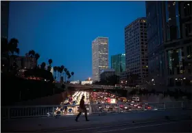  ?? Jae C. Hong/AP ?? Walking: a woman walks on a bridge as heavy traffic moves along the 110 Freeway during rush hour in Los Angeles. From drivers paying more for gas and families bearing heavier child care costs to workers still awaiting decent pay raises to couples...