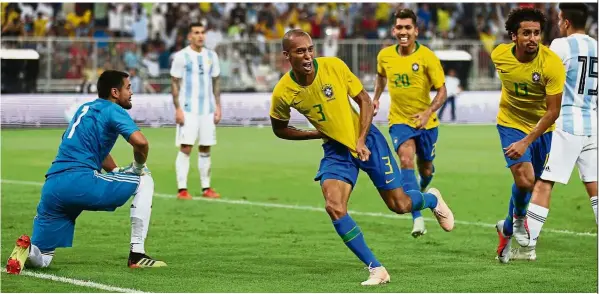  ?? — AFP ?? Glorious day: Brazil defender Miranda (second from left) celebratin­g after scoring a goal during the friendly match against Argentina at the King Abdullah Sport City Stadium in Jeddah on Tuesday.