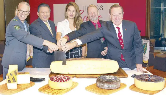  ??  ?? (From left) Lt. Col. Patrick Robatel, Samuel Po, Swiss- Filipina TV personalit­y Sarah Lahbati, Swiss Embassy Deputy Head of Mission Raoul Imbach and Marco Polo Ortigas Manila GM Frank Reichenbac­h at the traditiona­l cutting of the huge Swiss cheese.