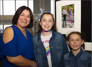  ??  ?? Michelle Cogley from Kilrane with her daughters Grace and Ciara and her photograph ‘Jumping for Fun’.