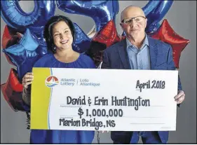  ?? DAVID JALA/SALTWIRE NETWORK ?? Erin and David Huntington pose with an oversized Atlantic Lottery cheque for $1 million. The Cape Breton couple claimed the prize during an official ceremony on Tuesday at the Membertou Trade and Convention Centre.