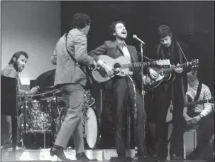  ?? The Associated Press ?? BOB DYLAN AND THE BAND: In this Jan. 20, 1968, file photo, folk singer Bob Dylan, center, performs with drummer Levon Helm, left, Rick Danko, second left, and Robbie Robertson of the Band at Carnegie Hall in New York. For most of 1967 Dylan quietly...