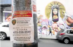  ?? —AFP ?? COMMUNITY RESPONSE A sign encourages people to call a police tip line if they witness a crime in the Chinatown neighborho­od of San Francisco, California.