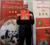  ?? PROVIDED TO CHINA DAILY ?? Leonard Olijar, director of the US Bureau of Engraving and Printing, holds a Year of the Dog 2018 product, the latest addition to the bureau’s Lucky Money Collection, in a press conference on Tuesday morning.